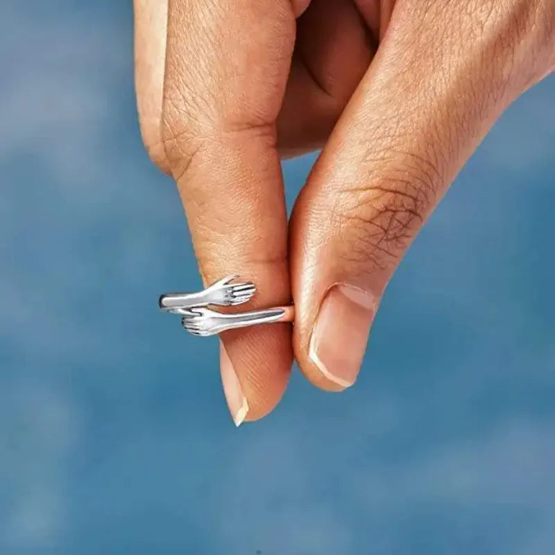 Adjustable stainless steel hug ring held between two fingers